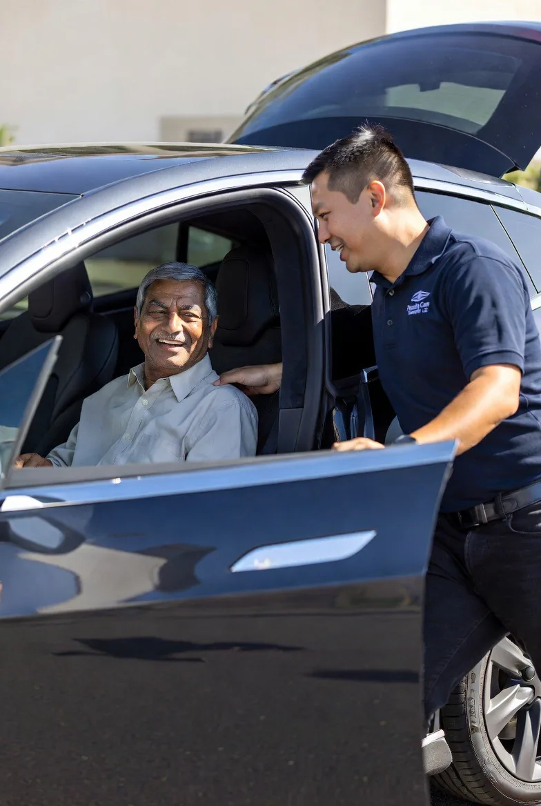 Companion helping a patient into the Tesla Model S outside a medical facility